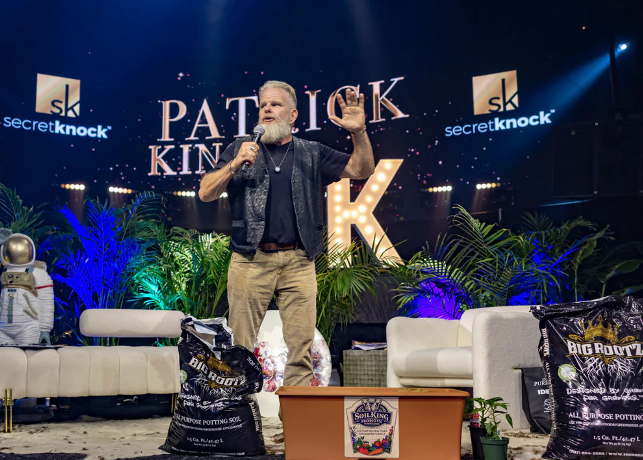 Patrick King speaking on stage at a conference